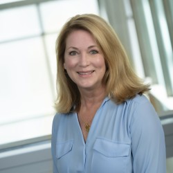 Kim Morton Headshot in light blue top