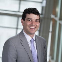 Robbie McLuckie Headshot in grey suit and lilac tie
