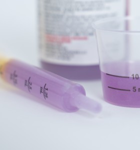 Medicine bottle, dosing cup, and medicine syringe