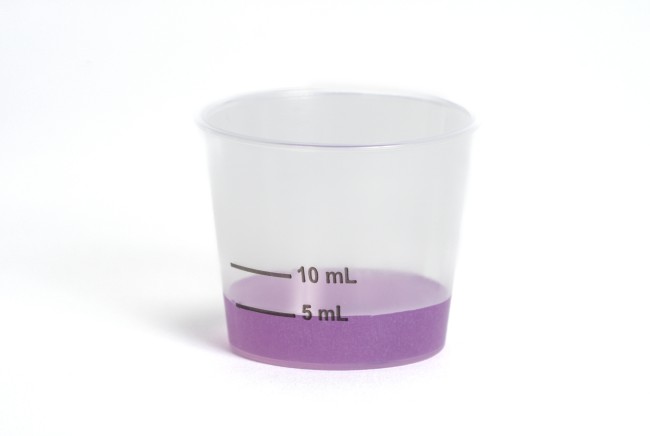 Dosing cup with purple liquid medicine