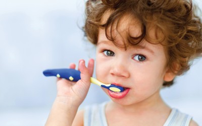Young brown haired child brushing teeth