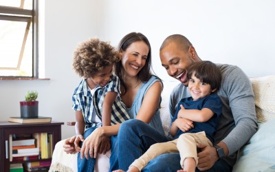 multi-racial couple with two children in living room