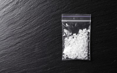 meth crystals in a plastic bag on a dark background meth crystals in a plastic bag on a dark background