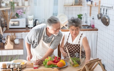 elderly couple of east Asian descent cooking together elderly couple of east Asian descent cooking together