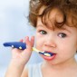 Young brown haired child brushing teeth