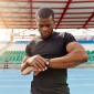 Athlete Outside with Fitness Tracker on a running track