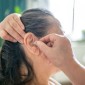 Woman attaching hearing aid