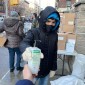 Young person giving hand sanitizer away
