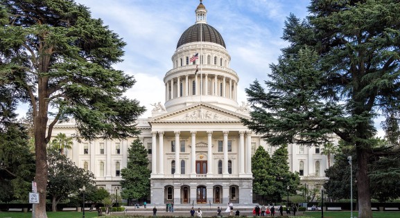 front view of the california state capitol flanked by trees