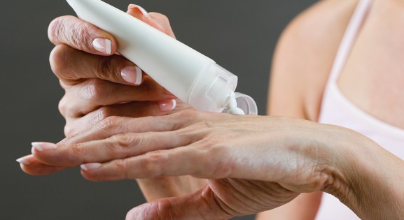 person applying lotion to hands