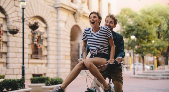 Happy young couple on a bike