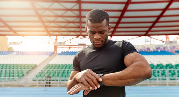 Athlete Outside with Fitness Tracker on a running track