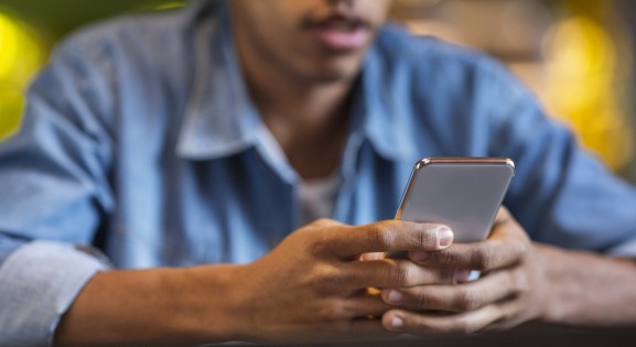 Black teenager on their smartphone