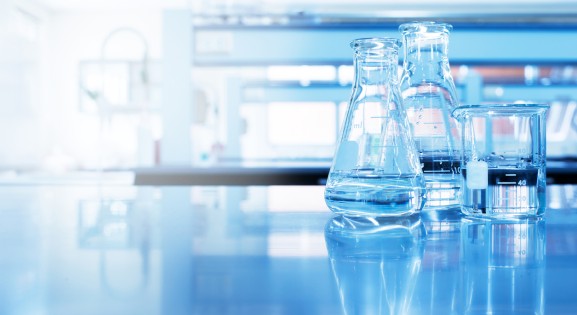 two flasks and a beaker on a table in a lab