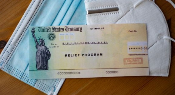 Image of government relief check and masks