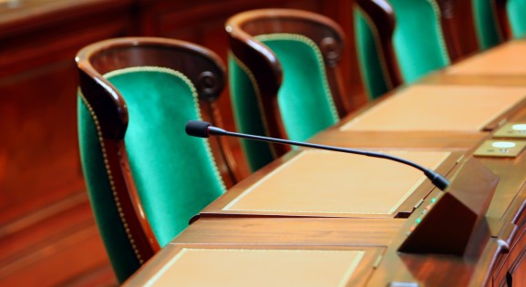 Empty Green Chair in Government Building with microphone