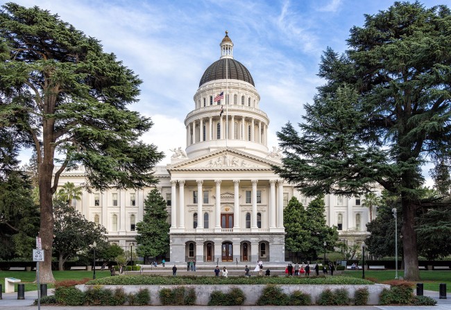 front view of the california state capitol flanked by trees